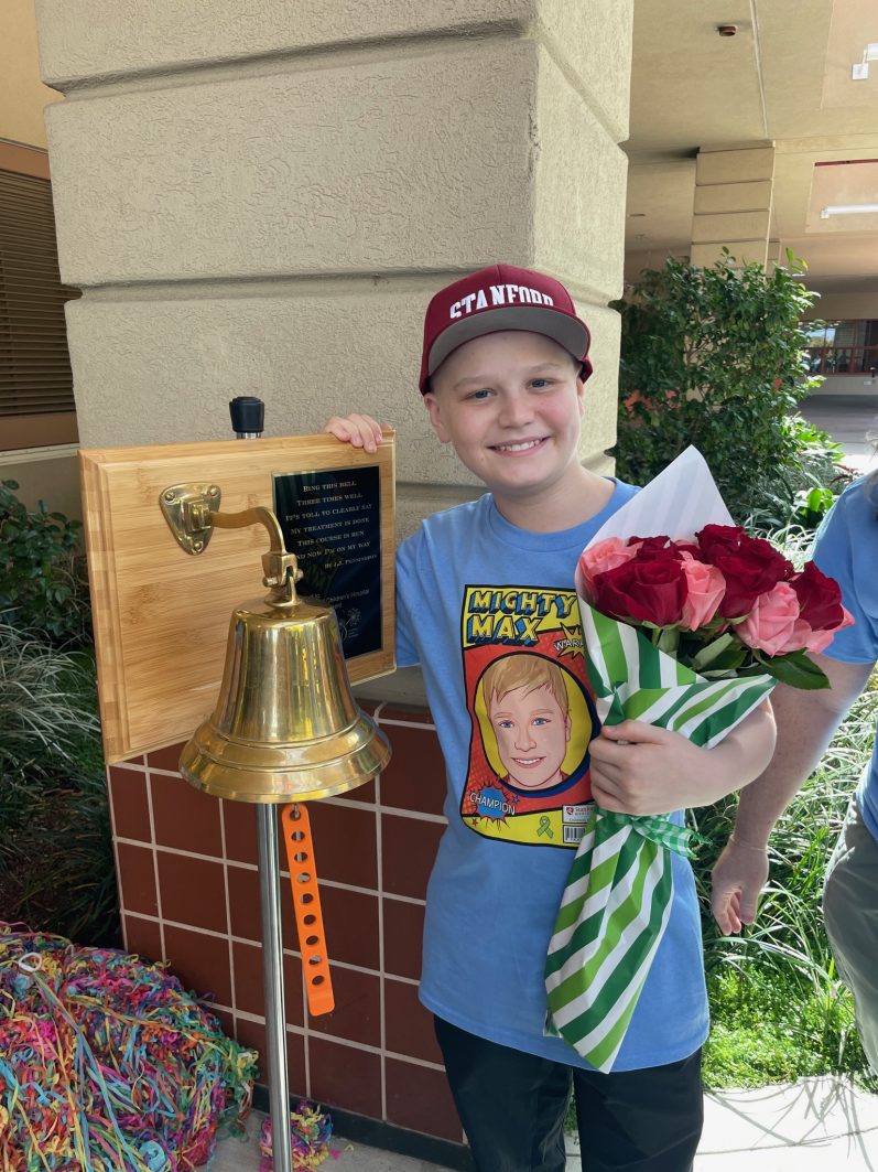 Max posing next to the celebration bell