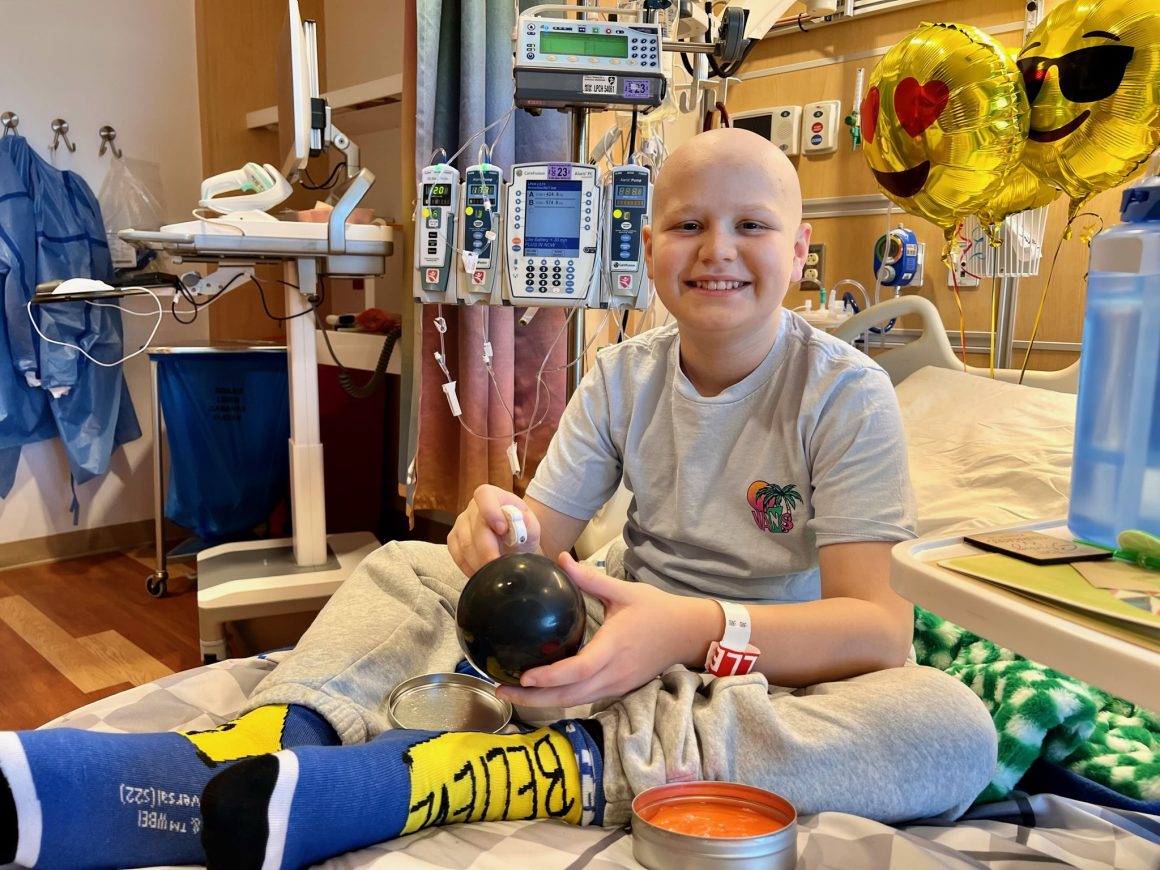 Max smiling in his hospital bed