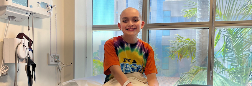 Cancer fighter smiling on hospital bed