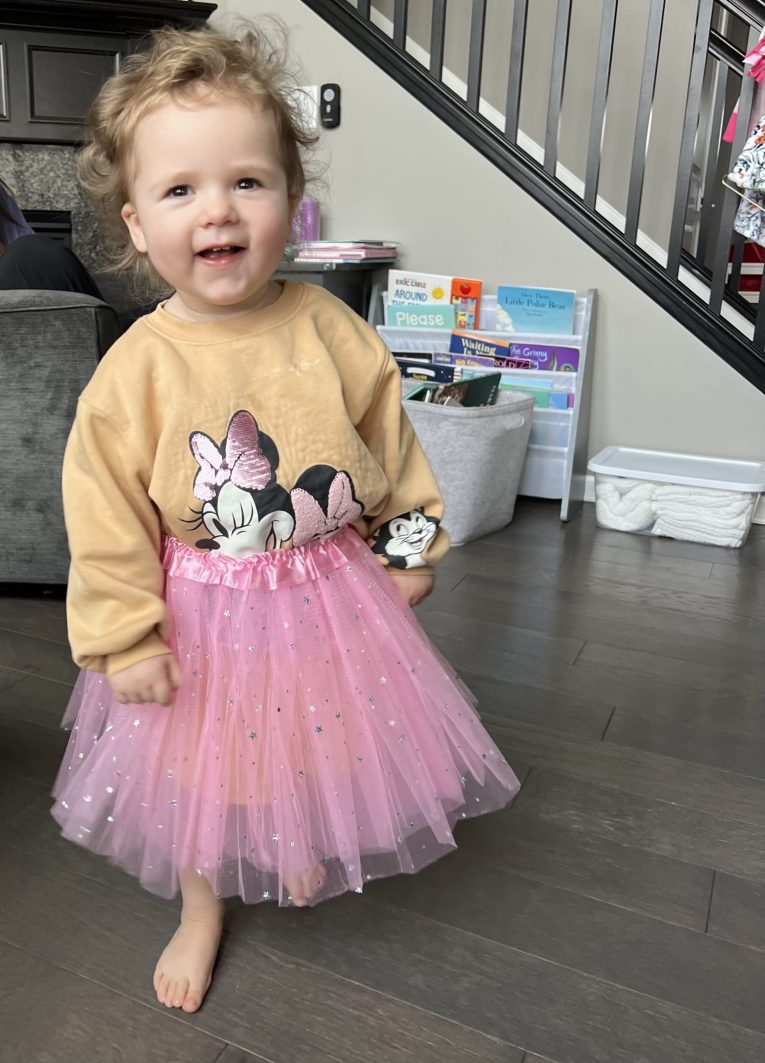 Emma posing in a pink tutu