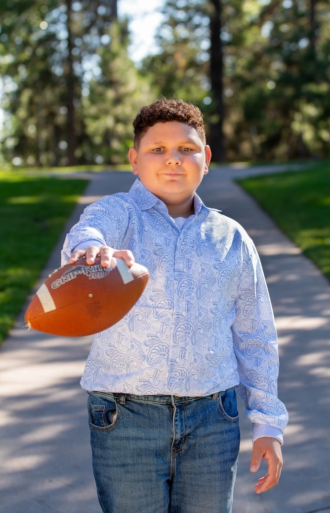 Isaac posing with a football
