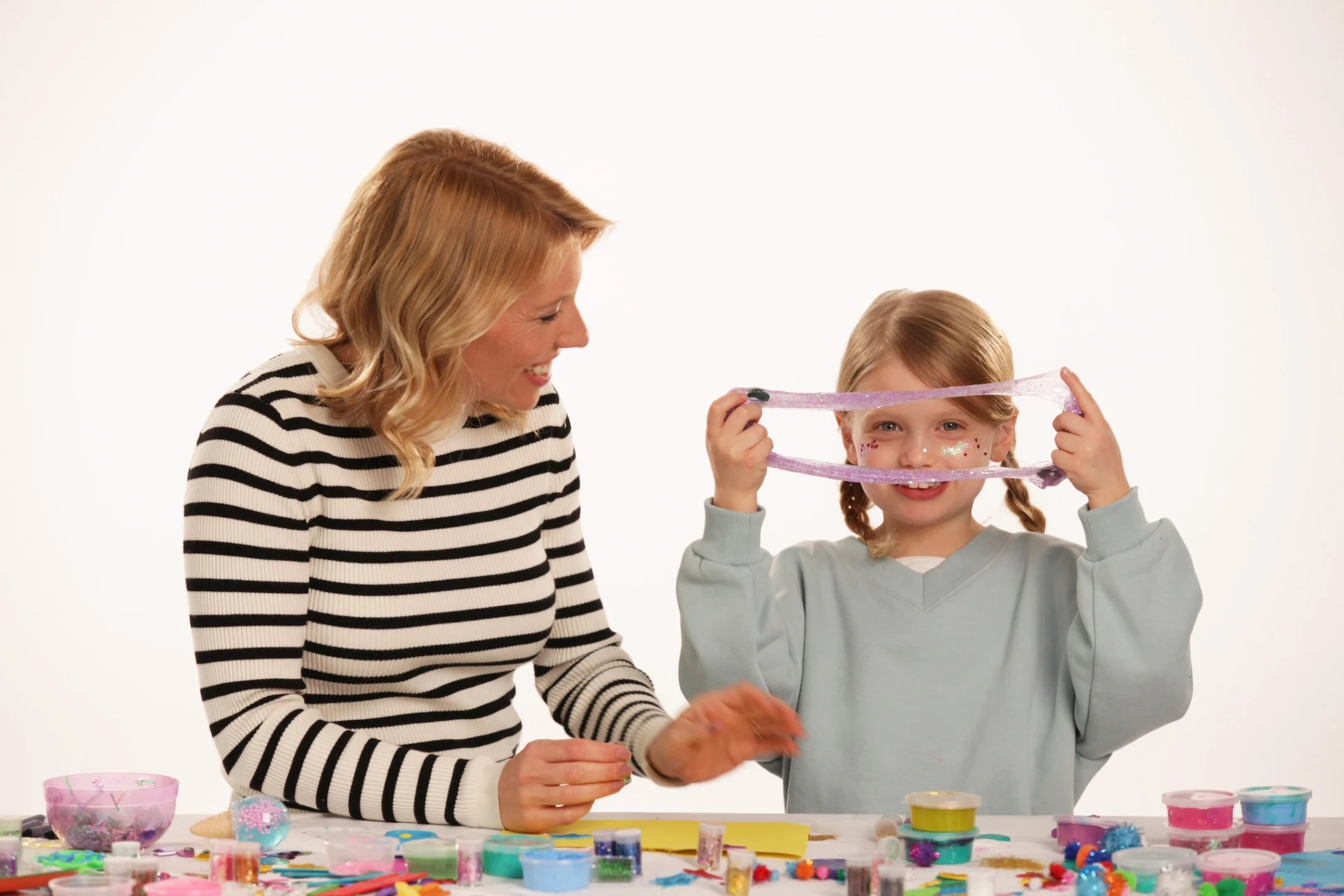 Ella playing with glitter alongside her mom Christina