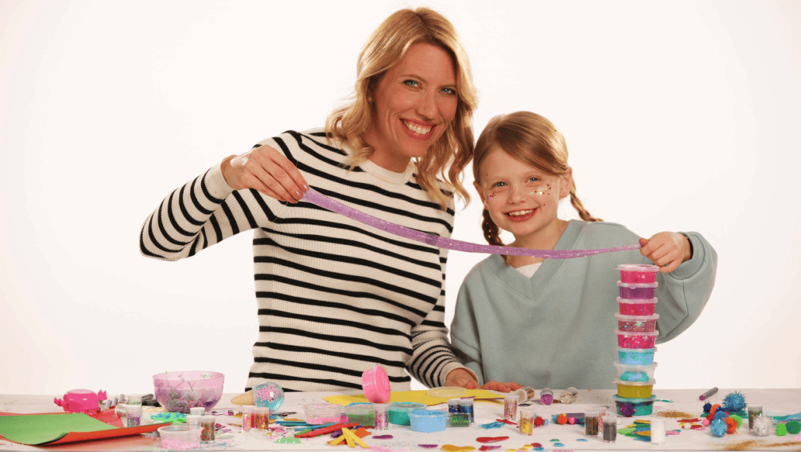 Ella, a cancer survivor and CCRF ambassador, and her mom Christina playing with glitter and colorful ribbons