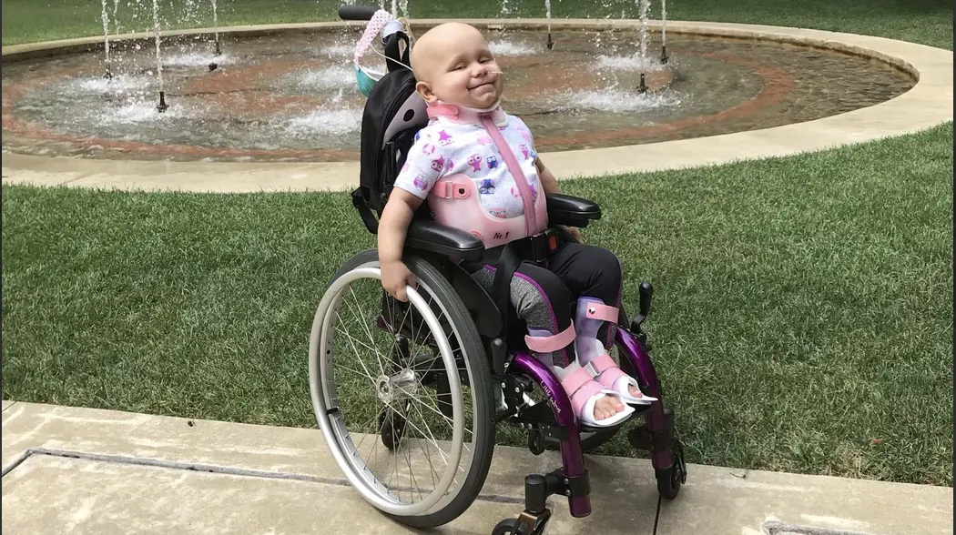 Emma sitting in her chair outside during treatment
