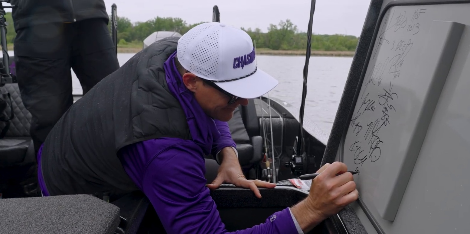 Coach O'Connell signing the boat 